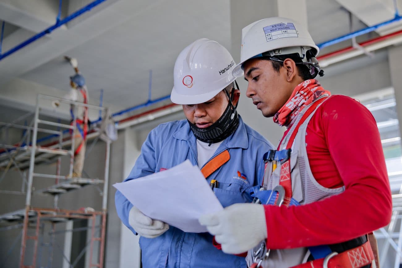 Construction crew reviewing plans on site