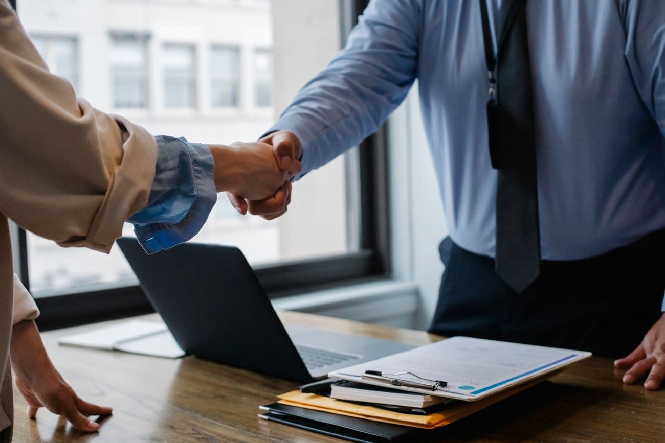 Handshake over clipboard documents at sign-off