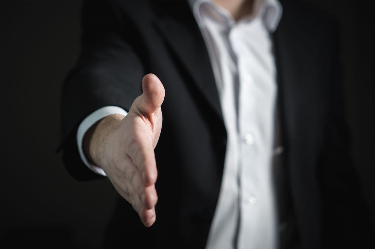 Businessman extending a hand in partnership