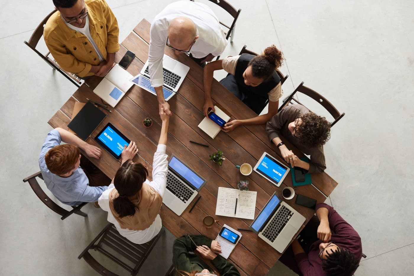 Top-down view of a consultancy team planning a project around a table