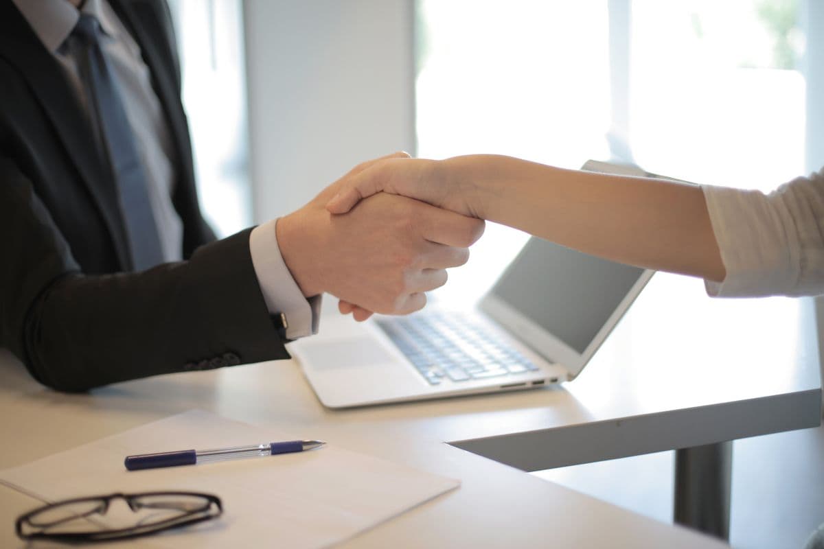 Handshake across a desk after a successful interview