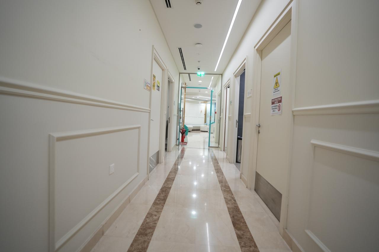 Clinical corridor with consultation and treatment room doors in a poly clinic in Dubai