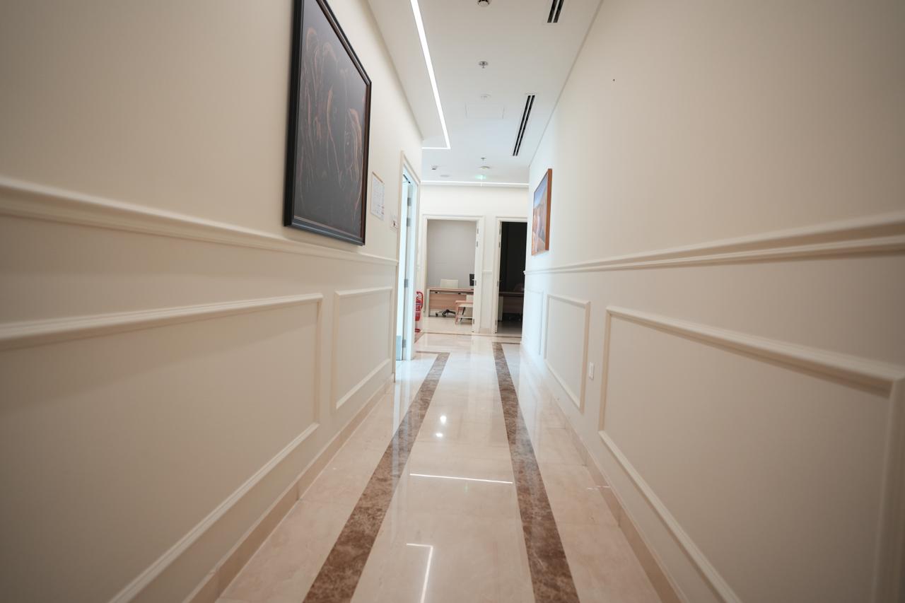Clinical corridor connecting eleven consultation rooms in a Dubai poly clinic
