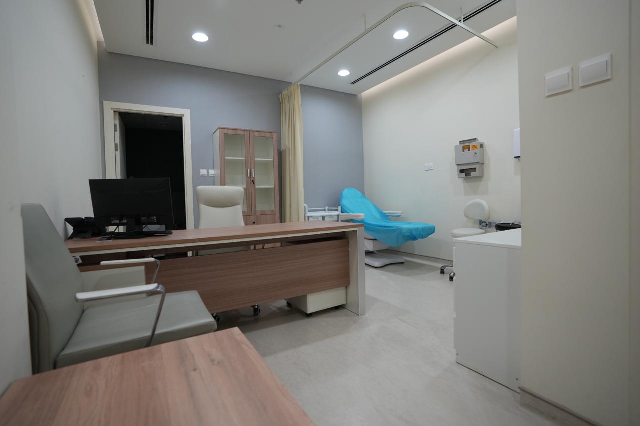 Consultation room with doctor's desk and examination couch in a licensed Dubai clinic