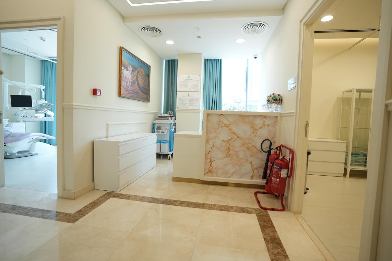 Reception counter and corridor leading to the clinical rooms in a Dubai poly clinic