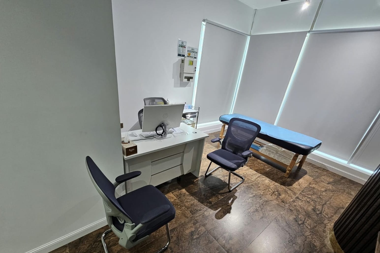Consultation room with examination couch and workstation in a medical centre in Al Danah, Abu Dhabi